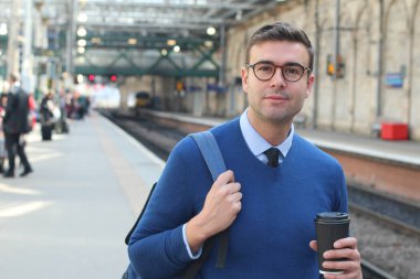 İş adamı retro tren istasyonunda yürüyor