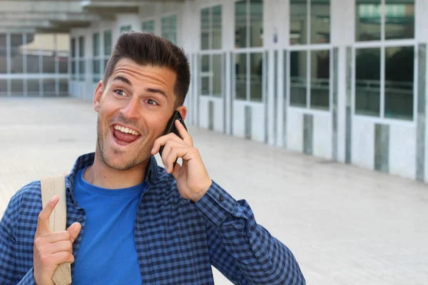 Student calling by phone on campus