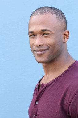 Mavi duvarın önündeki yakışıklı Afro-Amerikan 'ın yakın plan portresi.