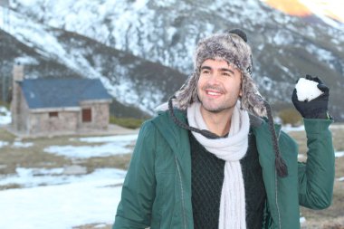 Oyuncu erkek bir kartopu atmak üzere.