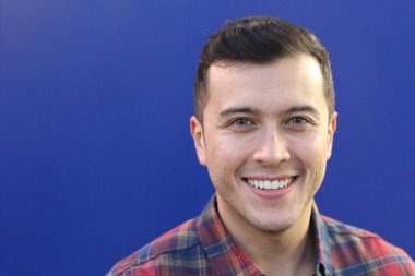 close-up portrait of handsome young man in plaid shirt