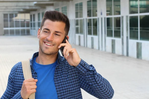 Student calling by phone on campus