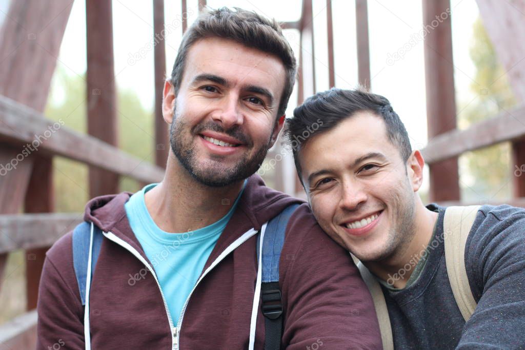 Gay couple enjoying hike at daytime