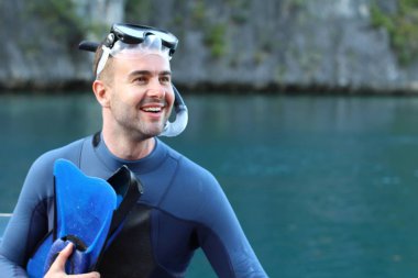 Teknede şnorkel ve maskeli yakışıklı genç adamın yakın plan portresi.
