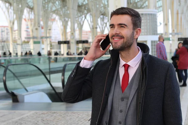 Businessman calling by phone at the airport