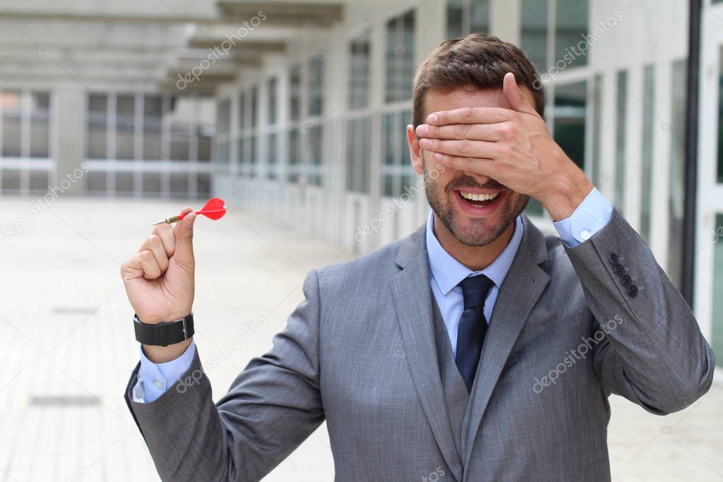 Impulsive businessman playing darts in office space