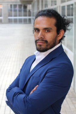 close-up portrait of handsome young businessman in blue jacket on street