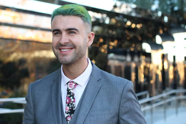 Elegant handsome man with green hair in office space