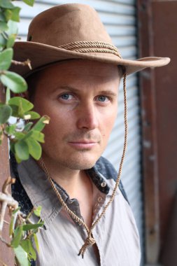 Kovboy şapkalı yakışıklı genç adamın yakın plan portresi.