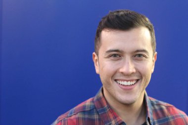 close-up portrait of handsome young man in plaid shirt