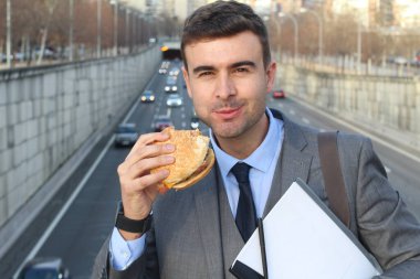 close-up portrait of handsome young businessman in suit on street