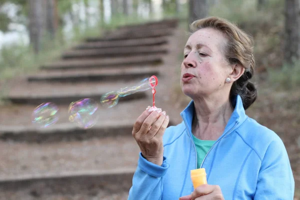 Donna Anziana Che Soffia Bolle Sapone Nel Parco Estivo Con — Foto Stock