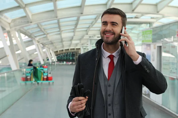 Businessman calling by phone at the railway station