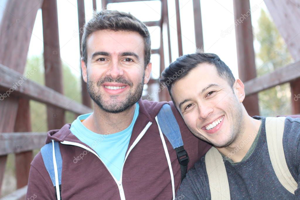 Gay couple enjoying hike at daytime