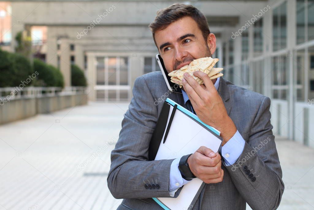 Businessman walking and eating at the same time