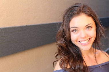 Açık havada duran melez üniversite öğrencisinin portresi.