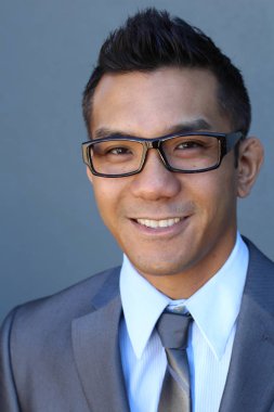 Portrait of young Asian man with glasses in office smiling
