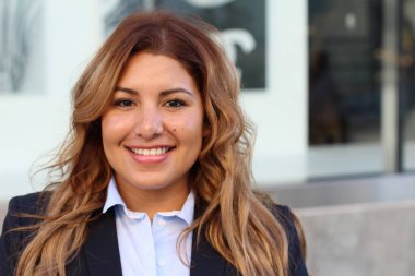 Beautiful smiley confident businesswoman portrait outside