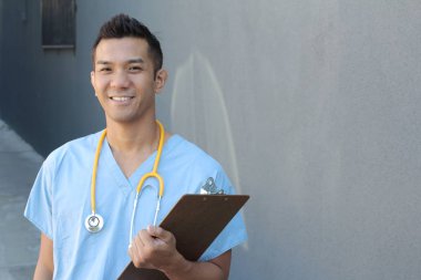 Male Filipino healthcare professional, portrait on studio background 