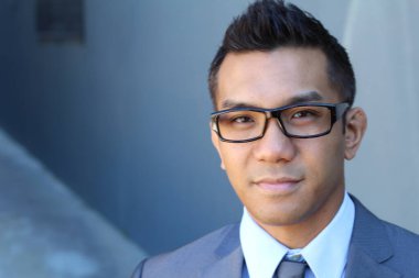 Portrait of young Asian man with glasses in office smiling