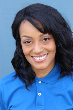 Closeup beauty portrait of a young and attractive African American black woman with perfect skin, softly smiling. Health and beauty outdoors lifestyle