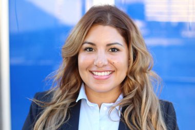 Beautiful smiley confident businesswoman standing on colorful background 