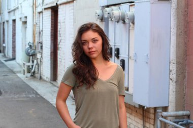 Açık havada duran melez üniversite öğrencisinin portresi.