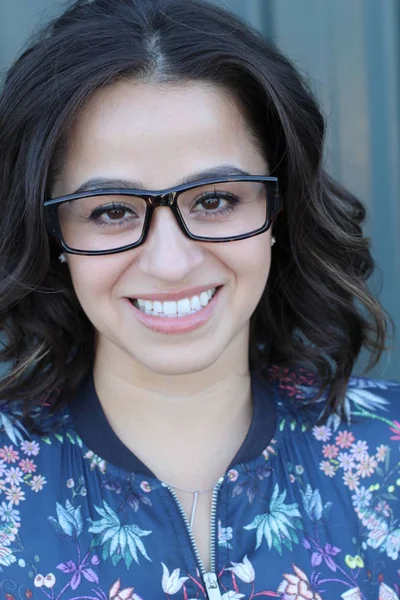 Portrait of naturally beautiful woman in her mid twenties with brown hair and brown eyes, shot outside in natural sunlight with copyspace