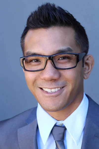 Portrait of young Asian man with glasses in office smiling