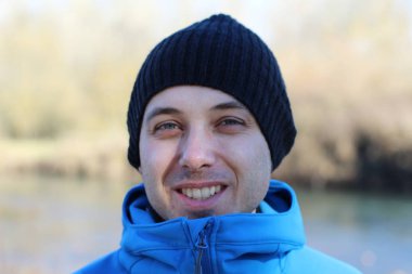 Sonbaharda doğa yürüyüşü sırasında yakışıklı bir gencin yakın plan portresi.