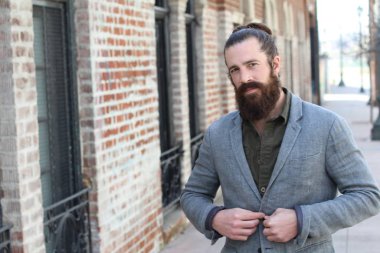 Tarz sahibi sakallı hippi modeli. Erkek saç stili, sokakta yaşam tarzı, tarlanın derinliği.