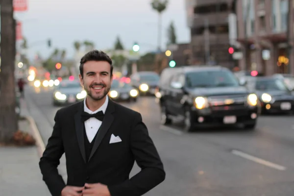Glamorous man in suit standing on urban background
