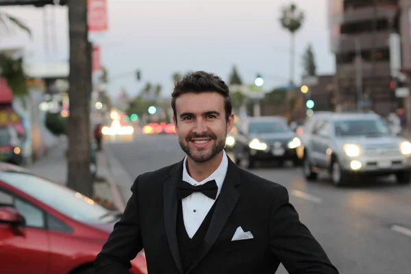 Glamorous man in suit standing on urban background