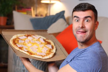 Cheerful young man holding a pizza clipart