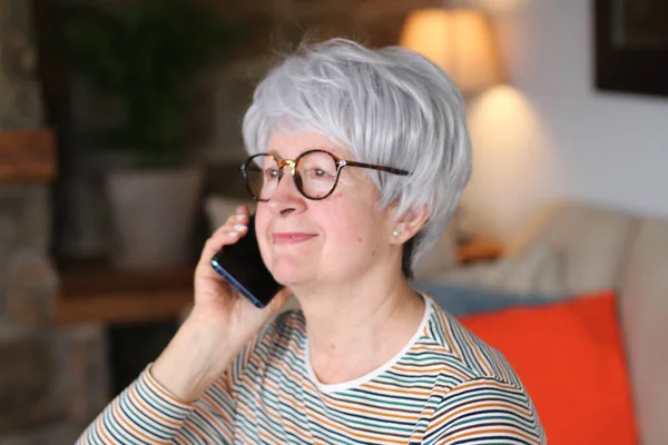 Senior woman calling by phone during coronavirus outbreak