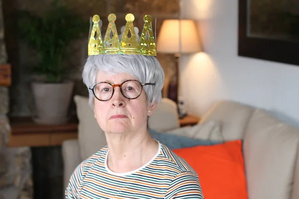 Arrogant senior woman wearing a crown