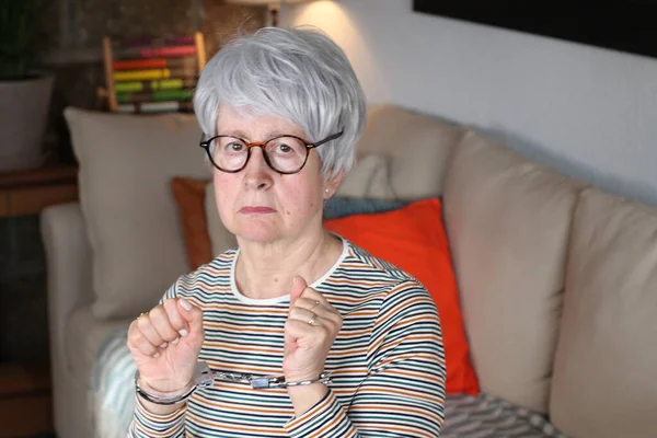 stock image Handcuffed grandmother in the house