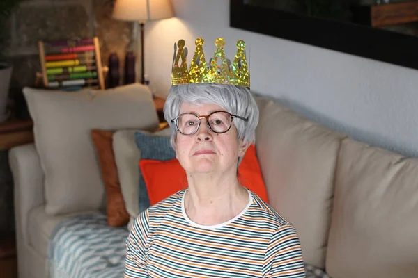 Arrogant senior woman wearing a crown