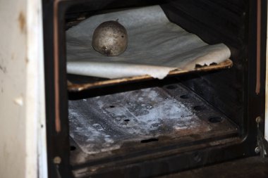 Baked beet tuber in the oven on baking paper, closeup.