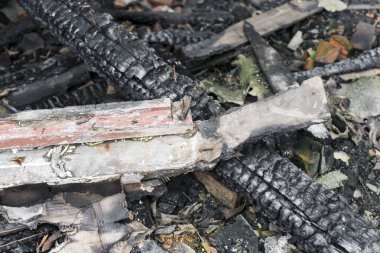 Burnt old boards with nails, close-up.