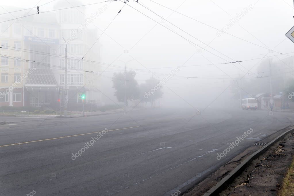 Komsomolskaya street and pension fund building on an early foggy morning, Oryol (Orel), Russia - June 8, 2019