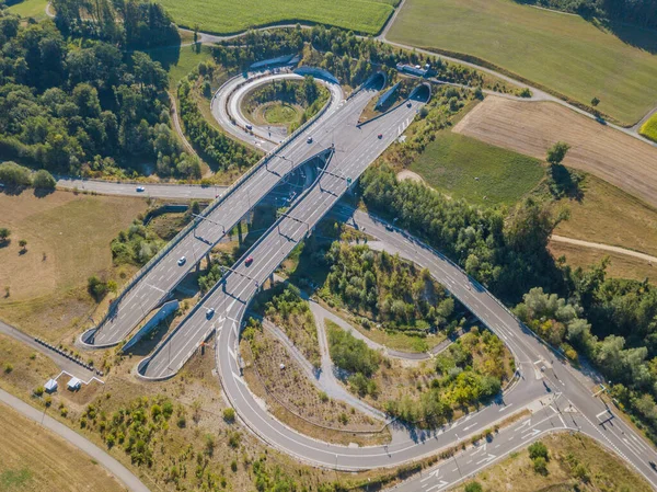 Aerial view of highway bridge and tunnel entrance in Switzerland