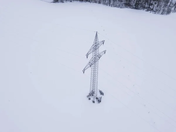 Aerial view of power line in snow covered landscape