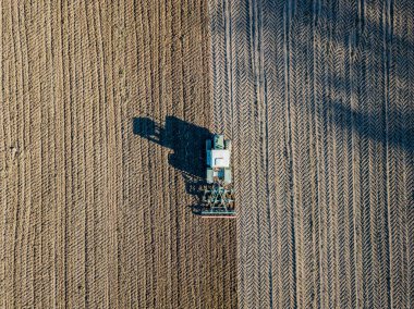 Aerial view of combine harvester on farmland in Switzerland  clipart