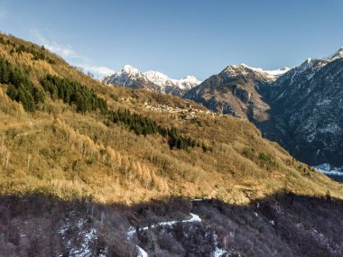 Aerial view of panorama of snow covered mountains above valley