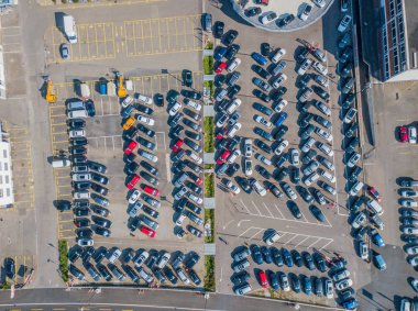 Aerial view of car park with many car standing in chaotic order 