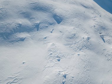 Aerial view of snow covered mountain peak in swiss alps clipart