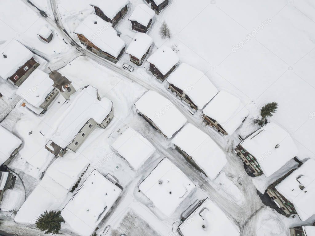 Aerial view of townwith snow covered roofs. Village in Switzerland in winter with a lot of snow.