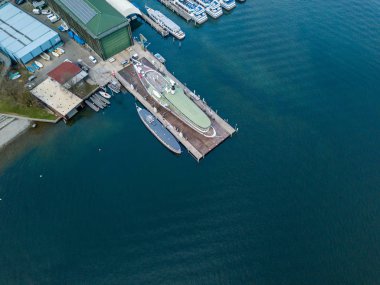 Aerial view of passenger ship in shipyard on land.