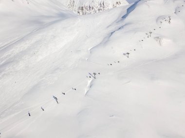 Aerial view of ski chairlift on snow covered mountain in Switzerland